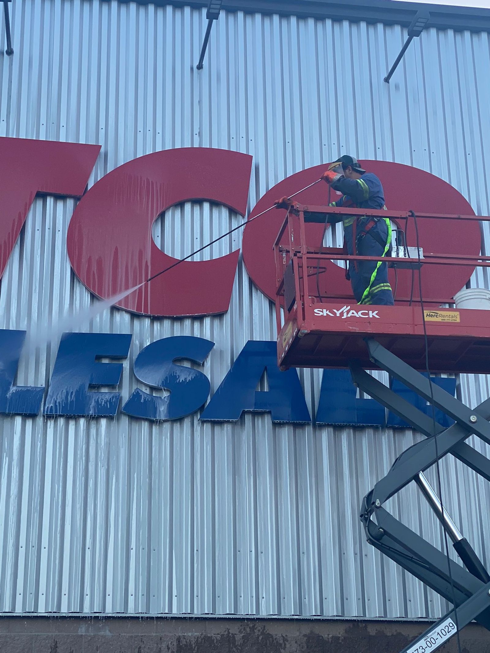 Commercial building exterior being pressure washed