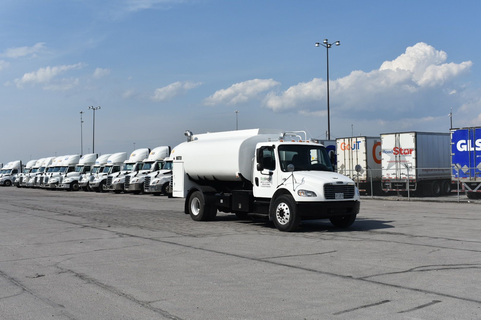 EcoLogic water truck and washed fleet lined up at a yard in Southern Ontario